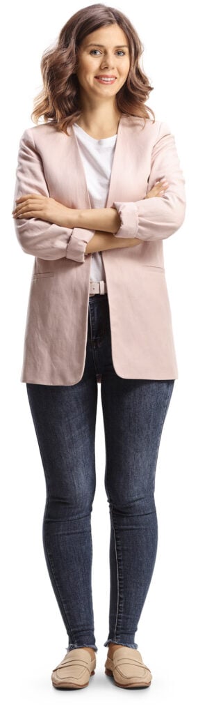 Full length portrait of a young casual woman posing and looking at camera isolated on white background.